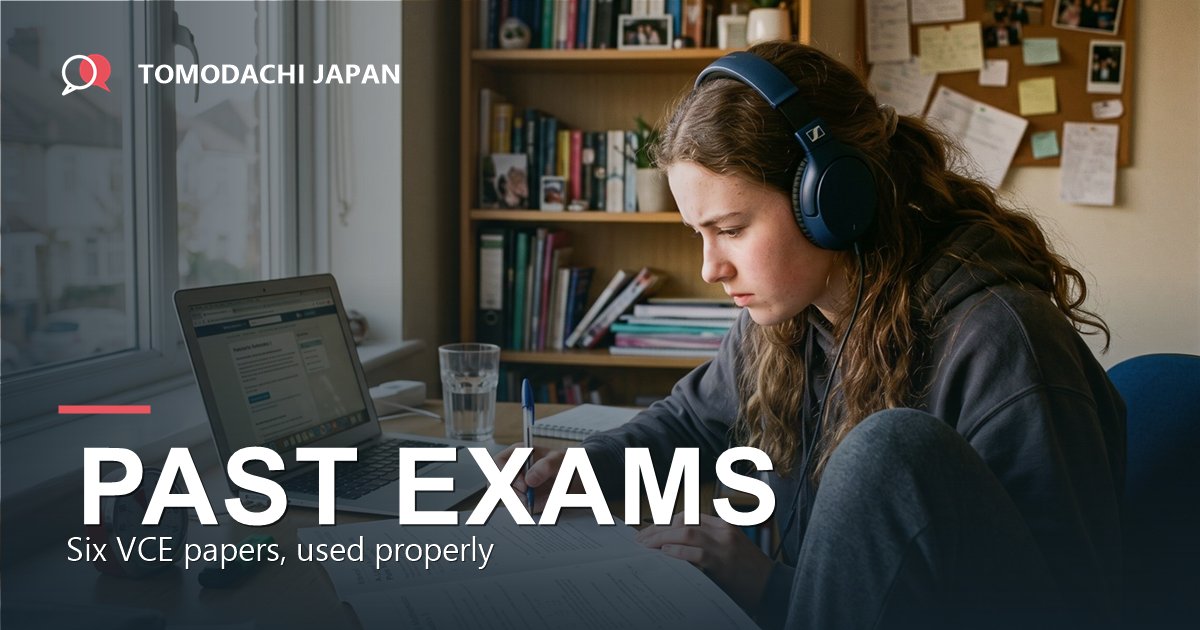 A student wearing over-ear headphones working through a printed past examination paper with a timer on the desk